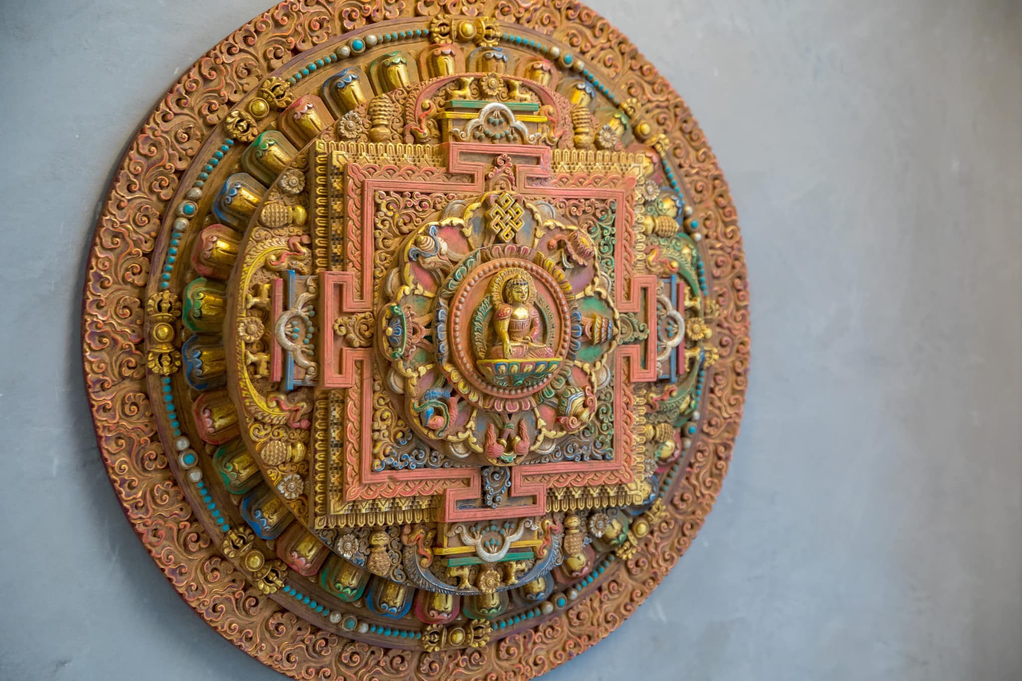 Close-up of the carved Nepalese mandala on the plaster wall at the door of the San Francisco studio