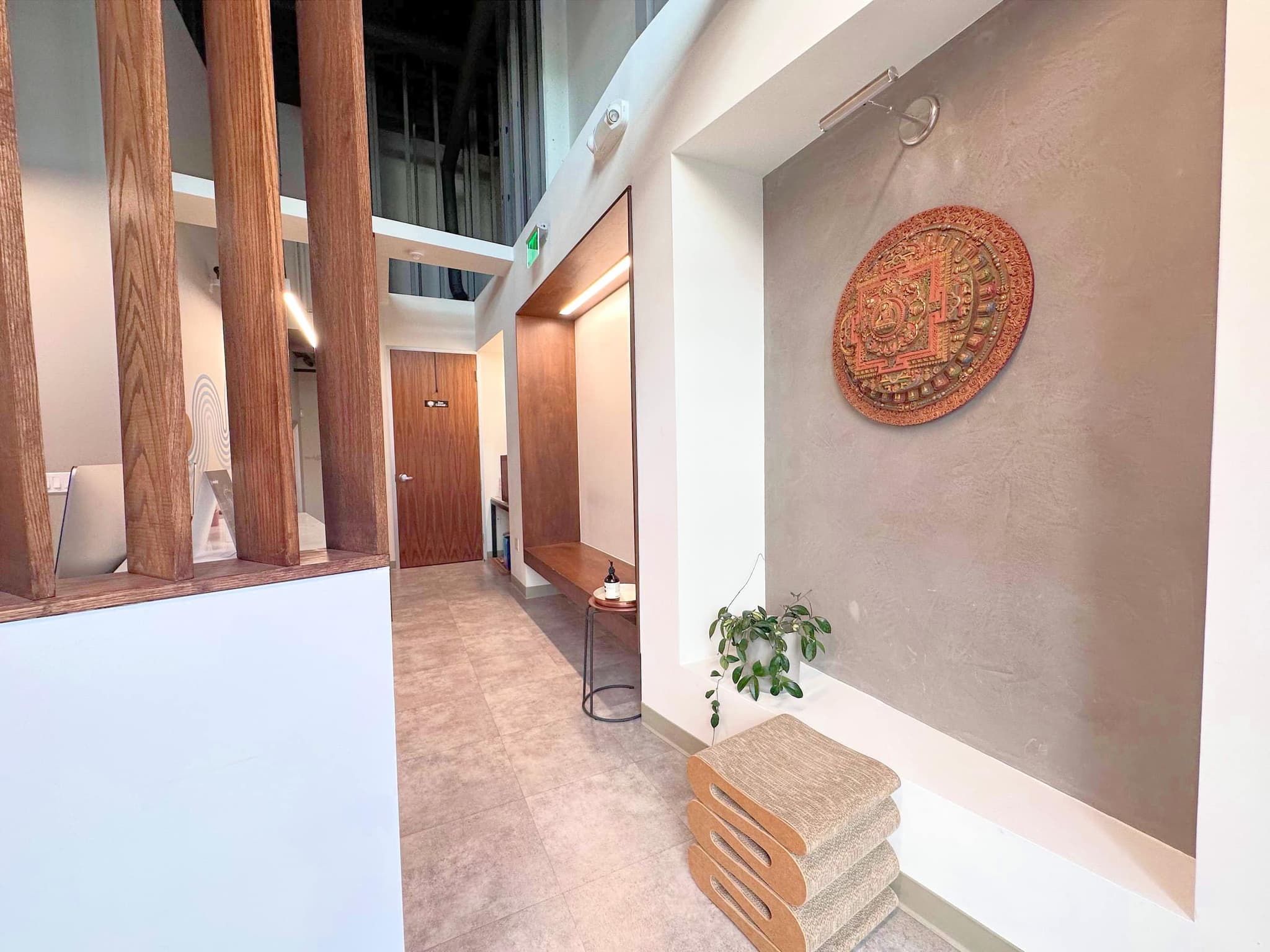 The warm SF entry — plaster, wood, and a handmade mandala