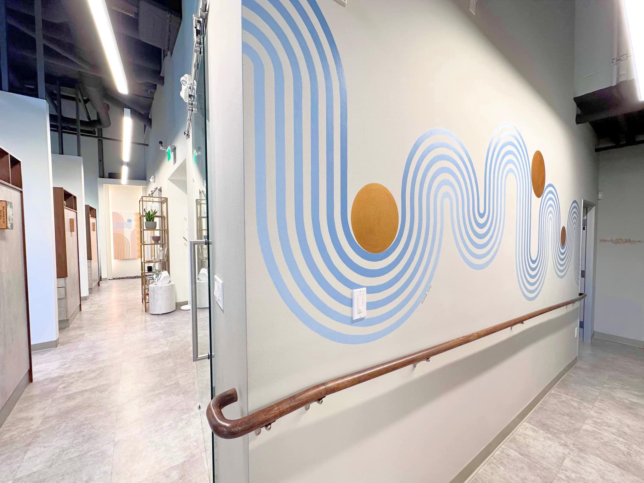 The blue wave mural along the main corridor of the San Francisco studio