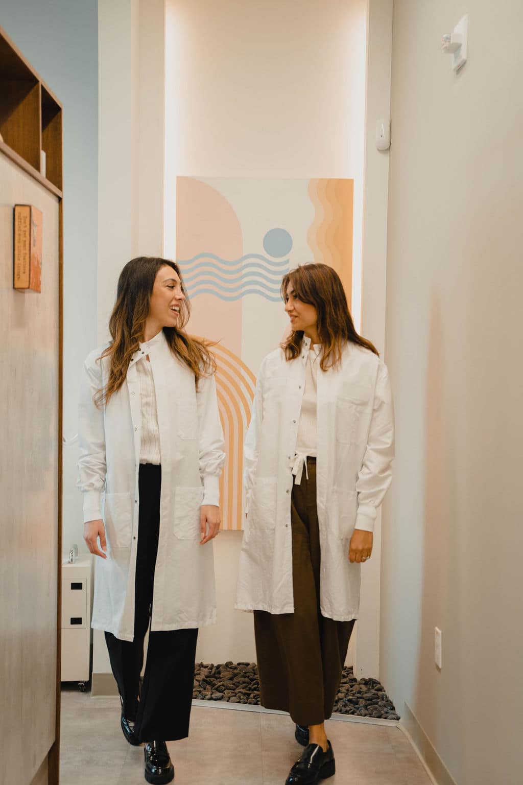 Two clinicians sharing a warm, easy moment