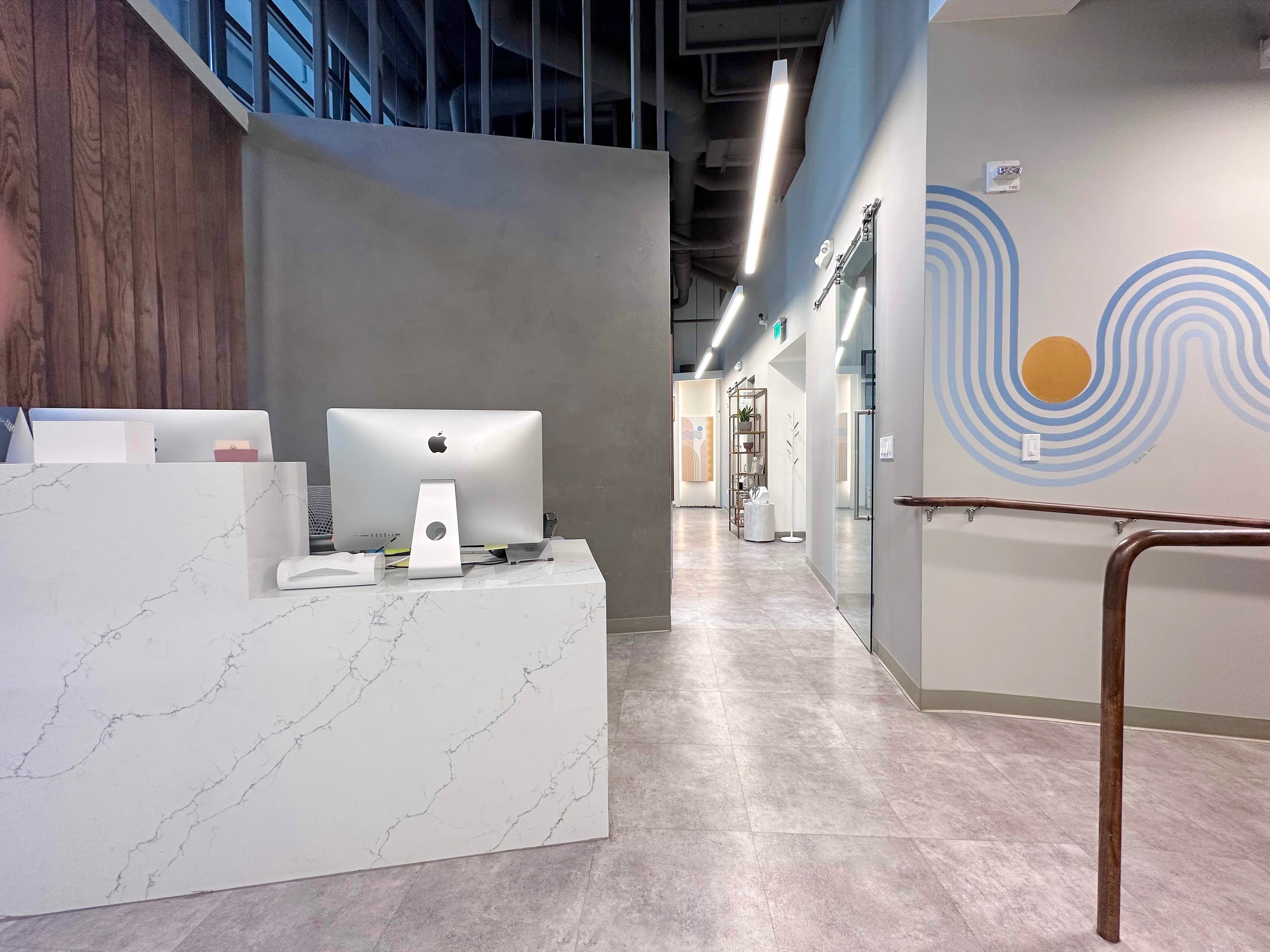 Zen Dental Studio SF hallway with marble desk and blue mural