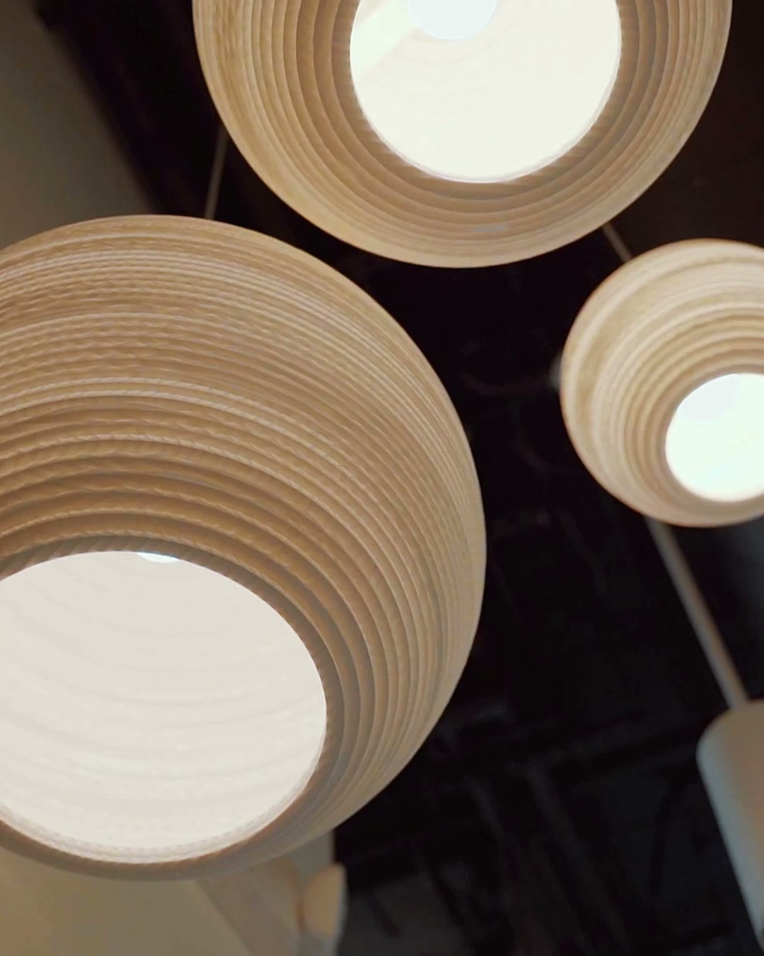 Round paper pendant lights glowing overhead at the Mountain View studio